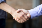 closeup-two-business-men-shaking-hands